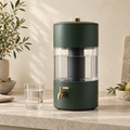Forest green countertop water filter with a glass of water